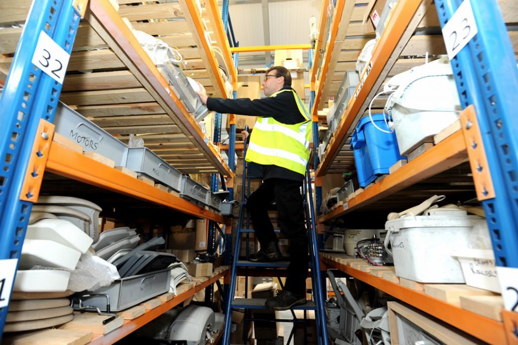 Picture of an engineer selecting parts in the Obam workshop