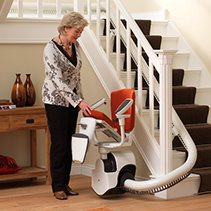 Picture of a lady getting her stairlift ready to use