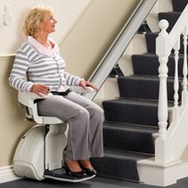 Picture of a lady using a straight stairlift