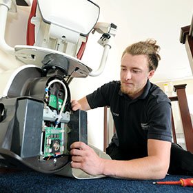 A picture showing an Obam Engineer installing a stairlift