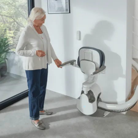senior woman with her stairlift in hallway