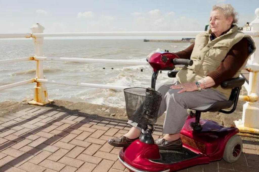 Women Riding Mobility Scooter On The Pier