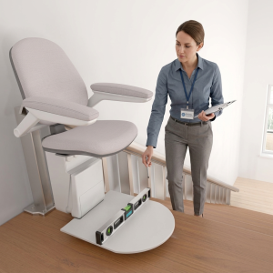 A woman in business attire inspects a stairlift with a clipboard, using a level tool at the bottom of the staircase—ideal for showcasing accessibility solutions on an Elementor Single Page site. #36021.
