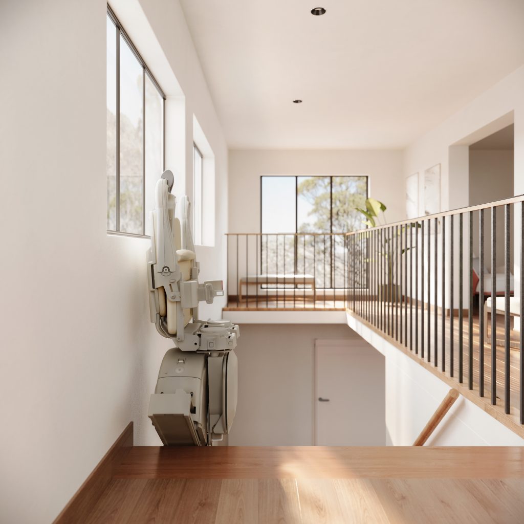 A Savaria K2 straight stairlift is installed along a wooden staircase in a bright, modern home with large windows and sleek metal railings.