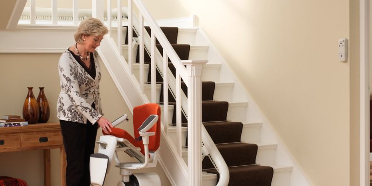 Picture of a lady folding the seat up on her curved stairlift